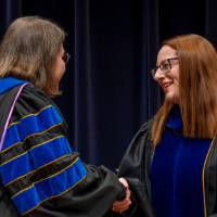 Faculty accepting award from Christine Rener